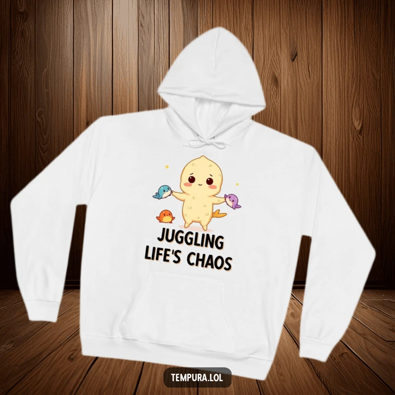 Funny tempura hoodie featuring a tempura character expertly juggling three tiny sea creatures, perfect for staying warm during performances or everyday life.