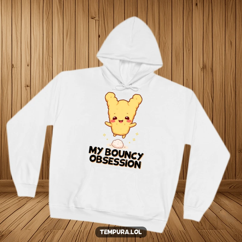 Funny tempura character joyfully bouncing a tiny sparkly rice ball, ideal for a warm and funny hoodie gift.